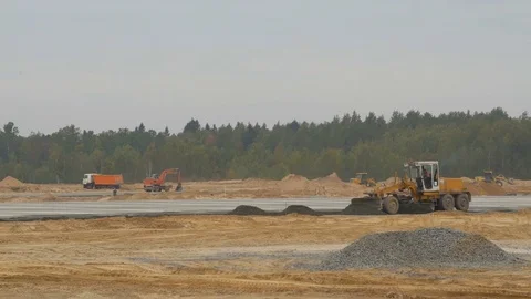 Grader or bulldozer leveling sand base on road. Construction machinery works on Stock-Footage 83497902