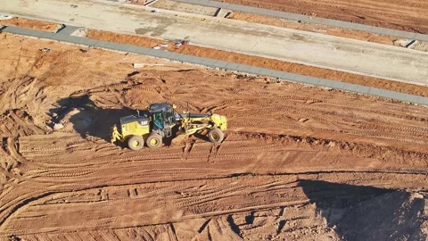 Grader positioning and lowering the blade for another levelling run Stock Footage 278340251