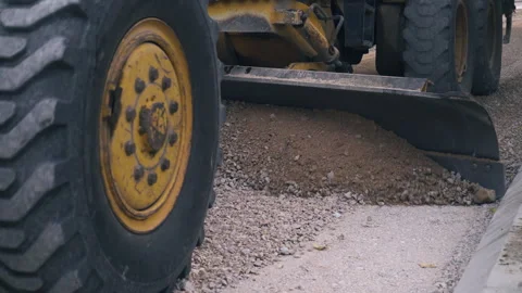 Grader scoop pushing and leveling gravel, street asphalting, road construction Video stock 292418685