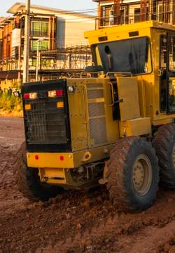 Grader is working on road construction. Grader industrial machine on Stock Photos