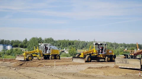 Graders with a long blade create a flat surface during the grading process Stock Footage 68147026