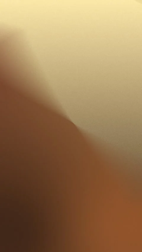 Gradient backdrop of warm brown and gold hues. Seamless loop background. 4K 動画素材 309855914