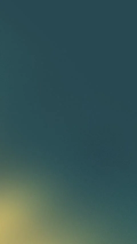 Gradient background in dark teal fading to soft yellow. Seamless loop 4K. Video stock 305344795