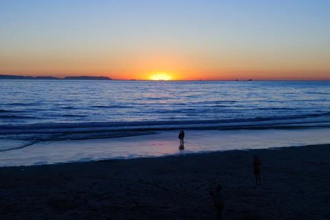 Gradient Beach Sunset &amp; Reflective Shoreline Stock Photos
