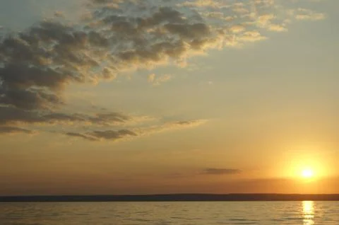 Gradient cloudy sunset off the coast of the great Russian river Stock Photos