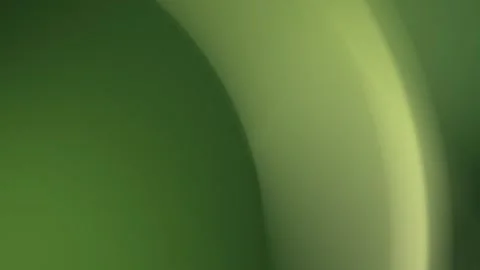 Gradient green arcs create an abstract seamless loop background. 4K Stock Footage 300840262