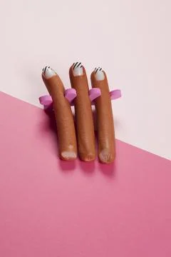 Gradient pink background and sausage manicure Stock Photos