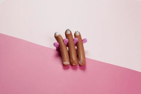 Gradient pink background and sausage manicure Stock Photos