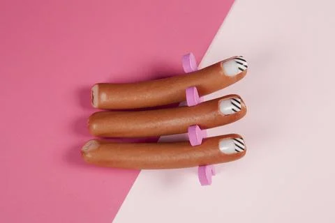 Gradient pink background and sausage manicure Stock Photos