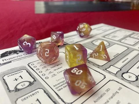 Gradient RPG Dice Set on Dungeons &amp; Dragons Character Sheet Stock Photos