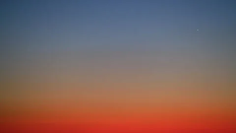 Gradient sky background with warm orange and purple hues at sunset or sunrise, Video stock 305492195