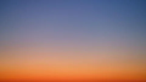 Gradient sky with blue and orange hues at sunset, time lapse. Natural backgro Foto stock