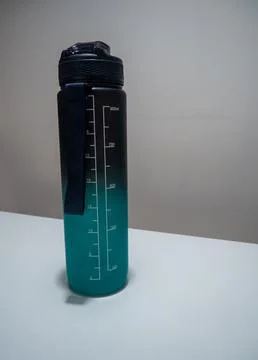 Gradient Water Bottle with Time Markers on White Table Stock Photos