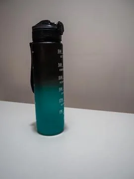 Gradient Water Bottle with Time Markers on White Table Stock Photos