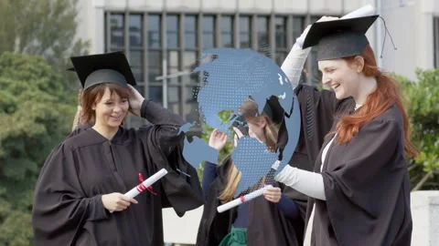 Grads celebrating on campus redhead pulling phone posing with diplomas dotted Stock Footage 333594757