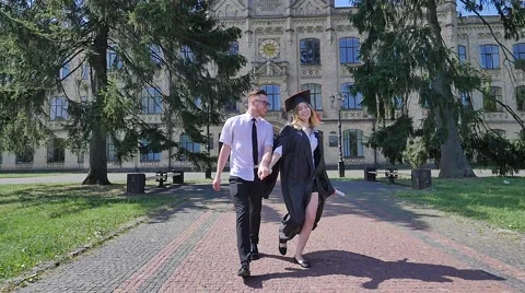 Graduands Having Fun Young Man Twisting a Woman in Mantle Happy Students Stock Footage 64813011