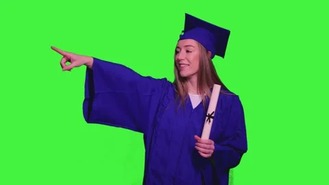 Graduated student pointing on green screen Stock Footage 302401492