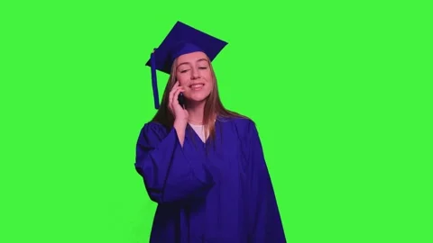 Graduated student using smartphone and talking on the phone on green screen Stock Footage 302401668