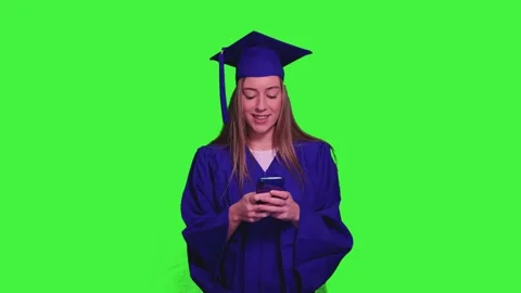 Graduated student using smartphone on green screen Stock Footage 302401533