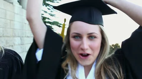 Graduated students raising their arms Stock Footage