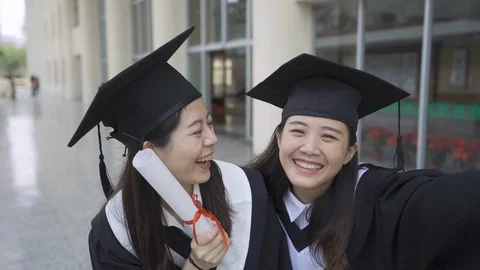 Graduating students taking selfie diploma scrolls Video stock 109428288