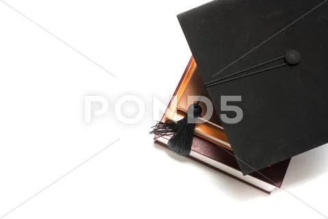 Graduation cap and book Stock Photos