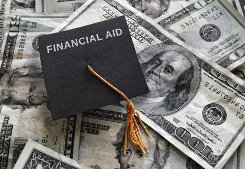 Graduation cap with Financial Aid text, on assorted money Stock Photos