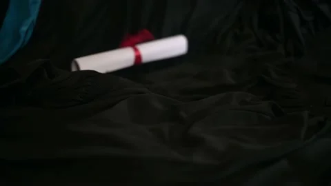 Graduation cap placed on a black academic gown,Education concept Stock Footage 136530141