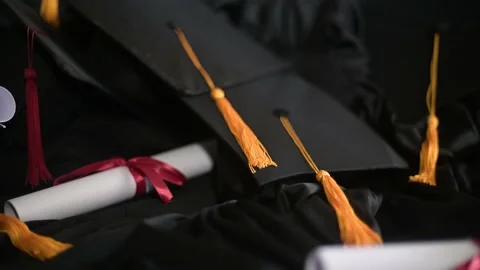 Graduation cap placed on a black academic gown,Education concept Stock Footage
