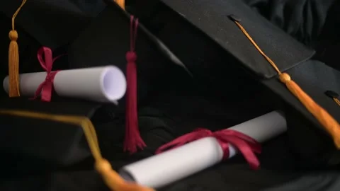 Graduation cap placed on a black academic gown,Education concept Stock Footage 136530406