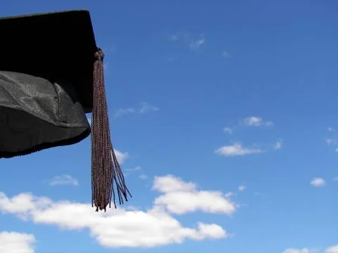 Graduation cap in sky Stock Photos