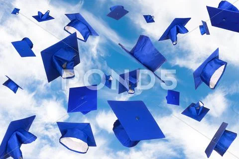 Graduation caps in flight Stock Photos