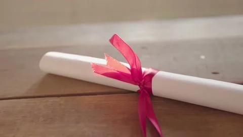 Graduation certificate placed on a wooden table Stock Footage 148101373