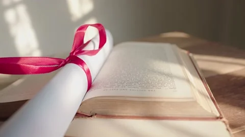 Graduation certificate placed on a wooden table Stock Footage 148101377