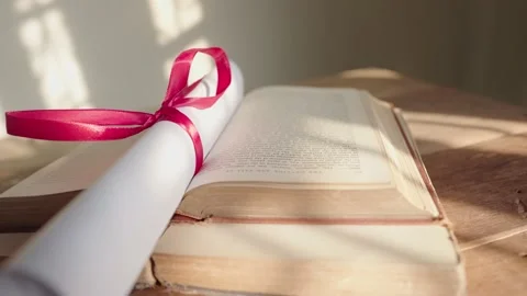 Graduation certificate placed on a wooden table Stock Footage 148101404