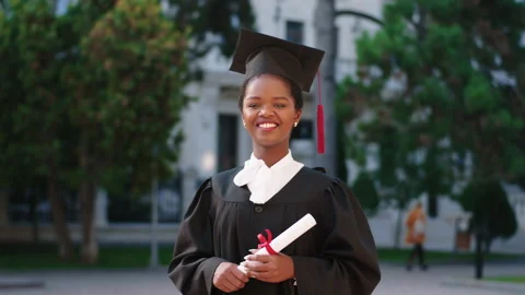 Graduation concept amazing looking black lady graduate posing with her diploma Stock Footage 162776471