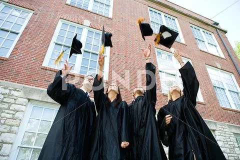 Graduation: graduates toss caps in air Stock Photos
