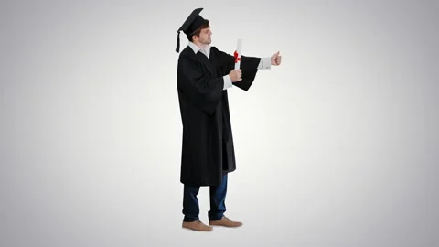 Graduation student showing thumb up on gradient background. Stockbeeldmateriaal 140529074