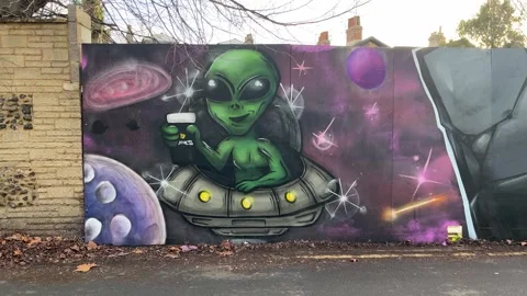 Graffiti of an alien in a UFO having a beer Stockbeeldmateriaal 330669203