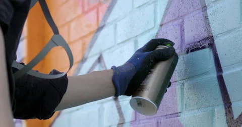 A graffiti artist drawing on a brick wall Video stock 238856569
