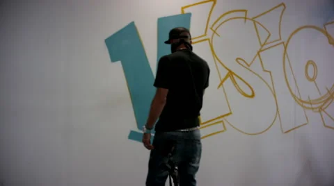 Graffiti artists drawing on wall at studio. Stock Footage 63429876