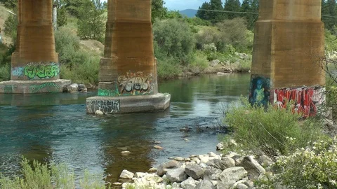 Graffiti bridge river pillars medium Stock Footage 112086324