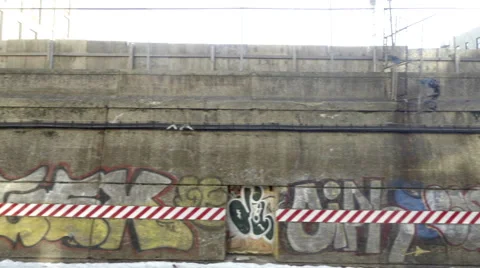 Graffiti on cement wall snow on subway tracks from B train NYC Stock Footage
