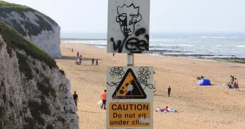 Graffiti cliff warning sign "Caution do not sit under cliffs" Botany Bay Stock Footage 321032937