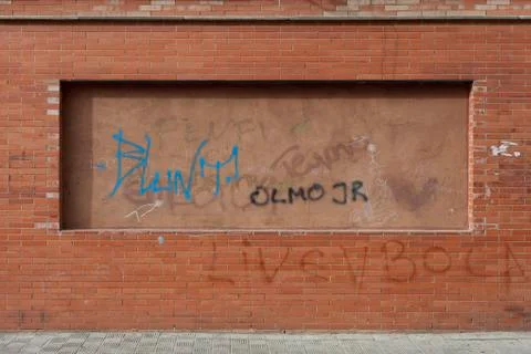 Graffiti covered brick wall in the city Stock Photos