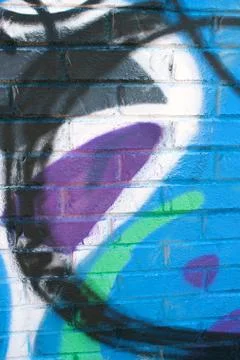 Graffiti covers warehouse brick wall Stock Photos