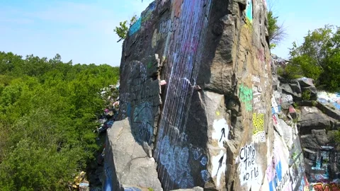 Graffiti Galore: A Summer Drone Dive into Quincy Quarry Stock Footage 246086347