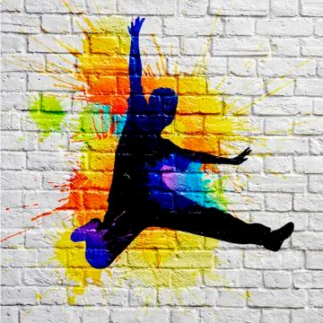 Graffiti jumping man on a brick wall 스톡 사진