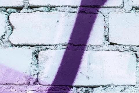Graffiti painted on a brick wall texture. Stock Photos