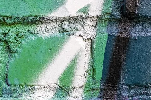 Graffiti painted on a brick wall texture. Stock Photos